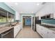 Modern kitchen with white cabinets, stainless steel appliances, and granite countertops at 152 58Th S Ave, St Petersburg, FL 33705