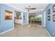 Bright living room with terrazzo floors and sliding glass doors leading to a screened patio at 152 58Th S Ave, St Petersburg, FL 33705