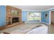 Living room features a stone fireplace, large window, and terrazzo flooring at 152 58Th S Ave, St Petersburg, FL 33705