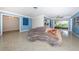 Open living room with a unique couch, terrazzo floors, and an open floor plan at 152 58Th S Ave, St Petersburg, FL 33705
