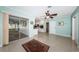 Open floorplan featuring Terrazzo flooring, sliding doors, and ceiling fan at 152 58Th S Ave, St Petersburg, FL 33705