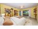 Bedroom with decorative shelving, ceiling fan, and a sliding glass door to the screened porch at 152 58Th S Ave, St Petersburg, FL 33705