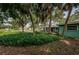 Inviting backyard with ample trees and greenery, offering shade and privacy at 152 58Th S Ave, St Petersburg, FL 33705