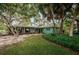 Lush backyard featuring a mix of lawn, trees, and greenery at 152 58Th S Ave, St Petersburg, FL 33705