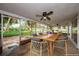 Enclosed porch with dining table and chairs, providing a peaceful outdoor space at 152 58Th S Ave, St Petersburg, FL 33705