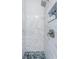 Shower with marble-style tile, and a built-in niche with blue mosaic tile at 152 58Th S Ave, St Petersburg, FL 33705