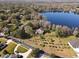 Aerial view of a lakefront property with mature trees at 15612 Howell Park Ln, Tampa, FL 33625