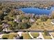 Aerial view of a home in a wooded area near a lake at 15612 Howell Park Ln, Tampa, FL 33625