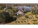 Aerial view of a lakefront home surrounded by trees at 15612 Howell Park Ln, Tampa, FL 33625