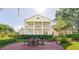 Beautiful outdoor patio featuring a large white home with a balcony and well manicured yard space at 15612 Howell Park Ln, Tampa, FL 33625