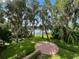 Serene backyard view featuring a peaceful green space and lake in the background at 15612 Howell Park Ln, Tampa, FL 33625