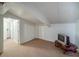 A finished basement area with white walls, a television, and carpet flooring at 15612 Howell Park Ln, Tampa, FL 33625