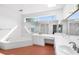 An updated bathroom with a bath tub and vanity at 15612 Howell Park Ln, Tampa, FL 33625