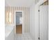 Bathroom with white vanity, striped wallpaper and updated fixtures at 15612 Howell Park Ln, Tampa, FL 33625