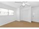 Bedroom with white walls and trim, a closet, and a ceiling fan at 15612 Howell Park Ln, Tampa, FL 33625