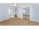 Light blue bedroom features closet with sliding mirror doors and an attached bathroom at 15612 Howell Park Ln, Tampa, FL 33625