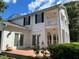 Stately home featuring a large patio with brick and tall columns, blending elegance with outdoor charm at 15612 Howell Park Ln, Tampa, FL 33625