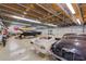 Spacious garage featuring car lifts, various vehicles, and ample workspace at 15612 Howell Park Ln, Tampa, FL 33625