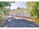 Attached four car garage with white doors and covered awning at 15612 Howell Park Ln, Tampa, FL 33625