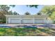 Spacious three-car garage with a classic white exterior and brick accents at 15612 Howell Park Ln, Tampa, FL 33625