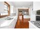 Bright kitchen with white cabinetry, long countertops, and copper-toned wood flooring at 15612 Howell Park Ln, Tampa, FL 33625