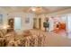Cozy living room featuring a kitchen, television, and carpet flooring at 15612 Howell Park Ln, Tampa, FL 33625
