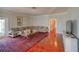 Comfortable living room with hardwood floors, a large sectional sofa, and stylish decor, perfect for relaxation at 15612 Howell Park Ln, Tampa, FL 33625