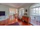 Elegant living room with hardwood floors, arched windows, and a comfortable seating area, creating a refined ambiance at 15612 Howell Park Ln, Tampa, FL 33625
