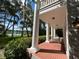Inviting porch with classic columns and a tranquil view of the lake and garden at 15612 Howell Park Ln, Tampa, FL 33625