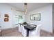 Stylish dining room featuring contemporary lighting, modern decor, and a window with natural light at 16106 Worlington Pl, Odessa, FL 33556