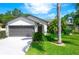 Charming single-story home featuring a well-manicured lawn, mature landscaping and an attached two-car garage at 16106 Worlington Pl, Odessa, FL 33556
