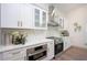 Stylish kitchen featuring white cabinets, granite countertops, and stainless steel appliances at 16106 Worlington Pl, Odessa, FL 33556