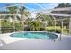 Beautiful screened-in pool area with lush landscaping, perfect for relaxation and outdoor entertainment at 16106 Worlington Pl, Odessa, FL 33556