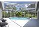 Enjoy a relaxing outdoor space with a screened-in lanai, a sparkling pool and comfortable seating area at 16106 Worlington Pl, Odessa, FL 33556