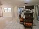Open-concept dining area adjacent to kitchen with tile floors and natural light at 17306 Livingston Ave, Lutz, FL 33559