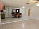 Open dining room with tile floors, adjacent to the kitchen, and featuring a view to an additional living area at 17306 Livingston Ave, Lutz, FL 33559