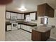 Traditional kitchen with white cabinets, wood accents, and modern appliances, ideal for cooking and entertaining at 17306 Livingston Ave, Lutz, FL 33559