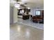 Open-concept living space with tile flooring, seamlessly connecting the living, dining, and kitchen areas at 17306 Livingston Ave, Lutz, FL 33559