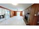 Open living room with tiled flooring, stone fireplace, and sliding glass doors to porch at 17306 Livingston Ave, Lutz, FL 33559