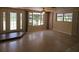 Bright living room with large windows and glass doors, offering ample natural light and outdoor views at 17306 Livingston Ave, Lutz, FL 33559