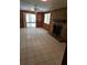 Cozy living room featuring tile floors, a stone fireplace, and sliding glass doors to an enclosed patio at 17306 Livingston Ave, Lutz, FL 33559