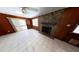 Inviting living room featuring a stone fireplace, bright windows, and sliding glass door at 17306 Livingston Ave, Lutz, FL 33559