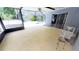 Covered pool area with white Adirondack chairs, great for outdoor lounging at 17306 Livingston Ave, Lutz, FL 33559