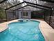 Inviting screened-in pool area featuring a spa and plenty of space for outdoor entertaining at 17306 Livingston Ave, Lutz, FL 33559