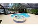 Screened in pool and hot tub with lush landscaping at 17306 Livingston Ave, Lutz, FL 33559