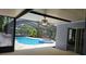 Screened in pool and hot tub area with ceiling fan and beautiful backyard at 17306 Livingston Ave, Lutz, FL 33559