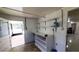 An indoor room with white walls and shelves, and a door leading outside at 17306 Livingston Ave, Lutz, FL 33559
