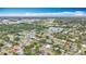 Aerial view of a neighborhood with lush greenery, a pond and an airport runway at 1737 Prince Philip St, Clearwater, FL 33755