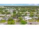 An aerial view of a neighborhood including a pond, airport and lush greenery at 1737 Prince Philip St, Clearwater, FL 33755