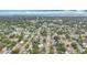 Expansive aerial shot of a residential area with a water tower and a cityscape in the distance at 1737 Prince Philip St, Clearwater, FL 33755